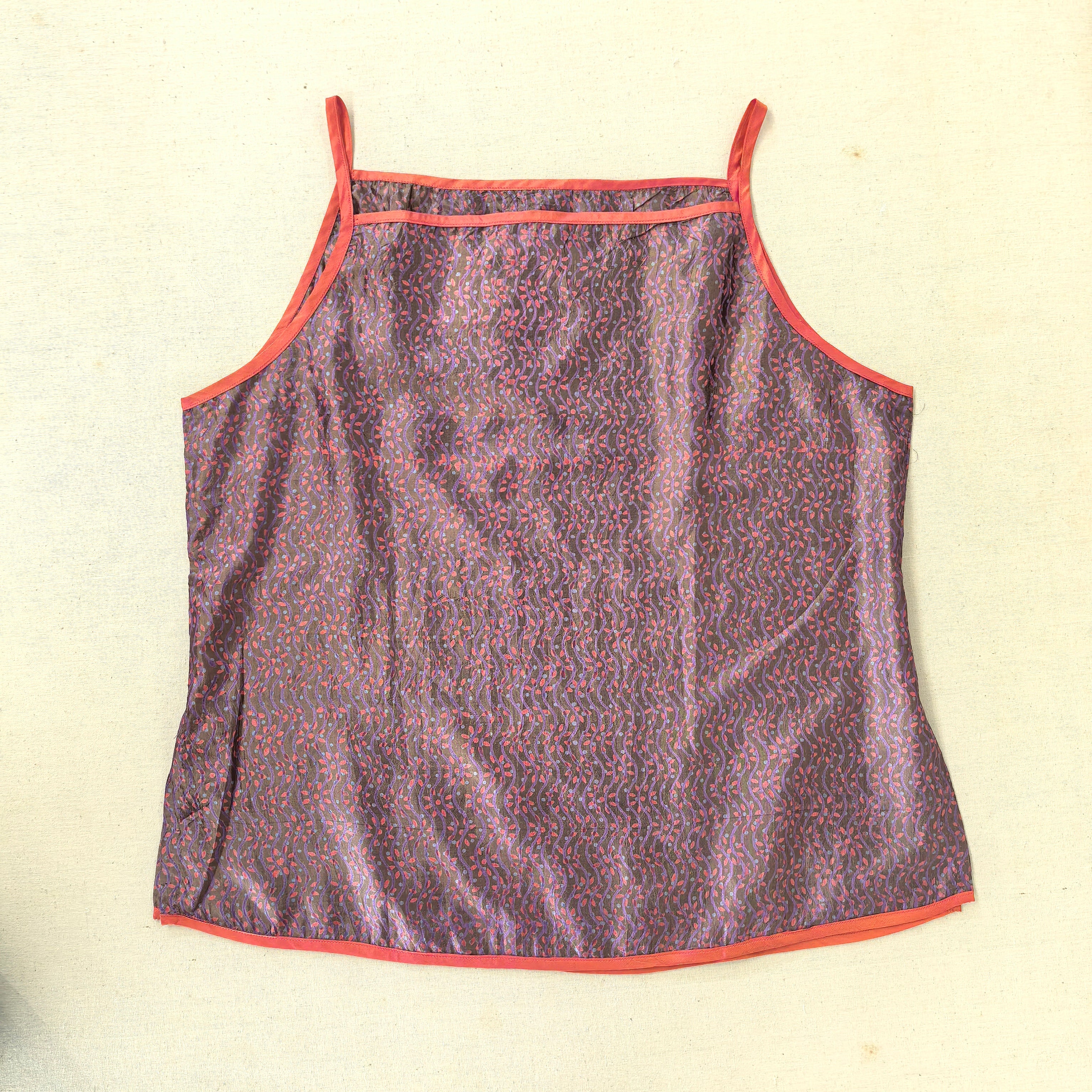 Purple fabric with red trim on a beige background